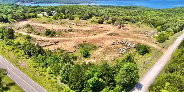 Image 2: Expansive land parcel featuring partial clearing,