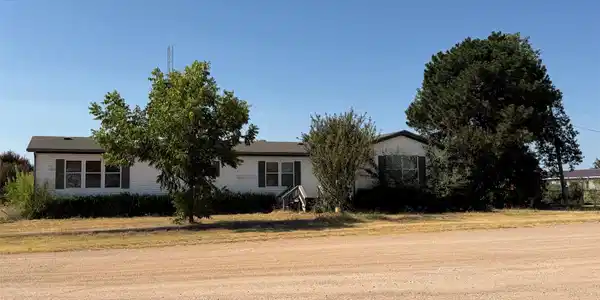 Image 3: White siding exterior with dark shutters, multiple