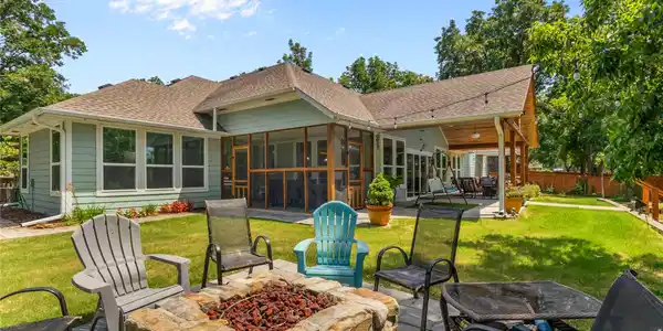 Image 2: Expansive backyard featuring a stone fire pit, a s