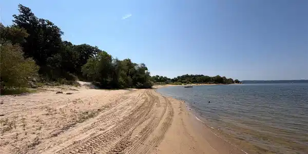 Image 4: Sandy Bass Bay beach just steps from the home