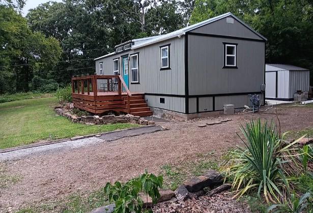 Image 3: Contemporary home with a gray exterior, black trim