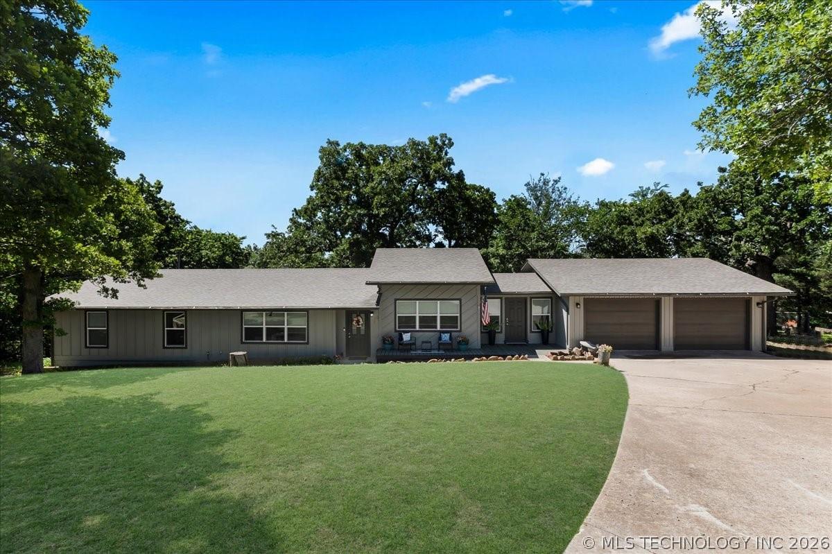 Image 2: Ranch-style exterior with gray vertical siding, a