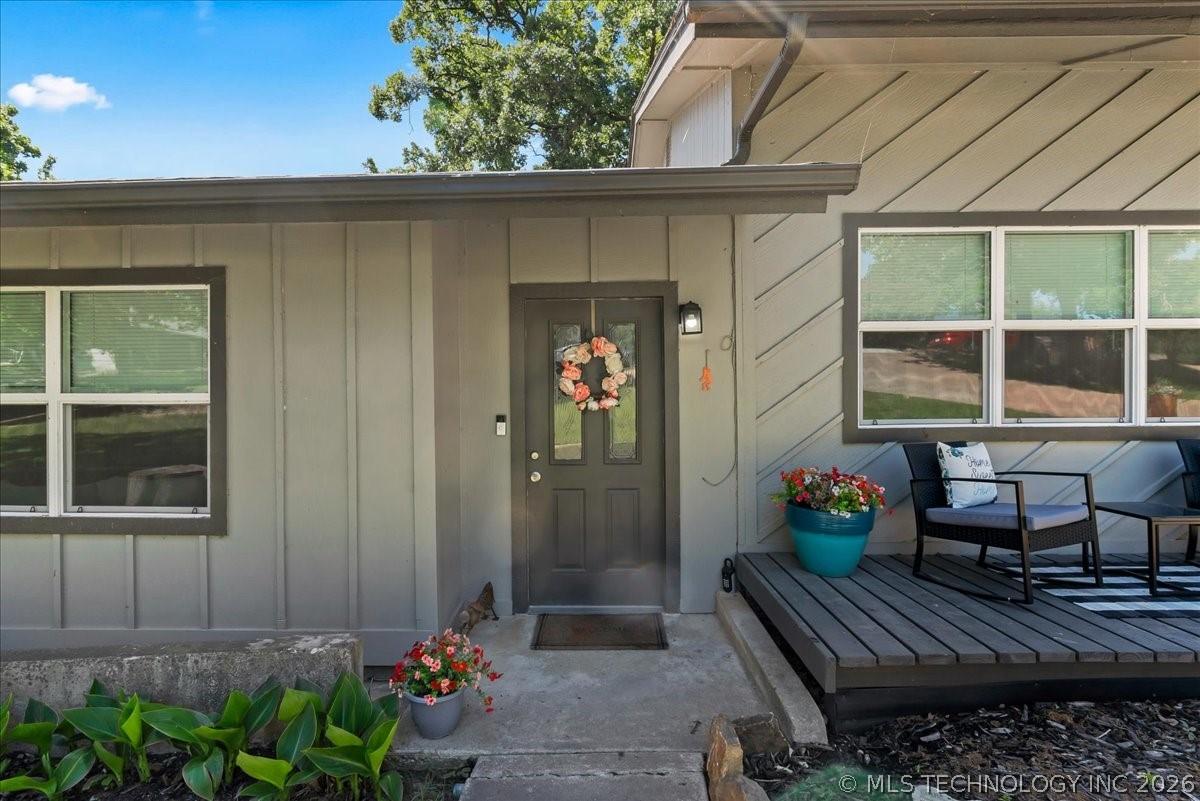 Image 3: Inviting front entry with a dark gray door and an