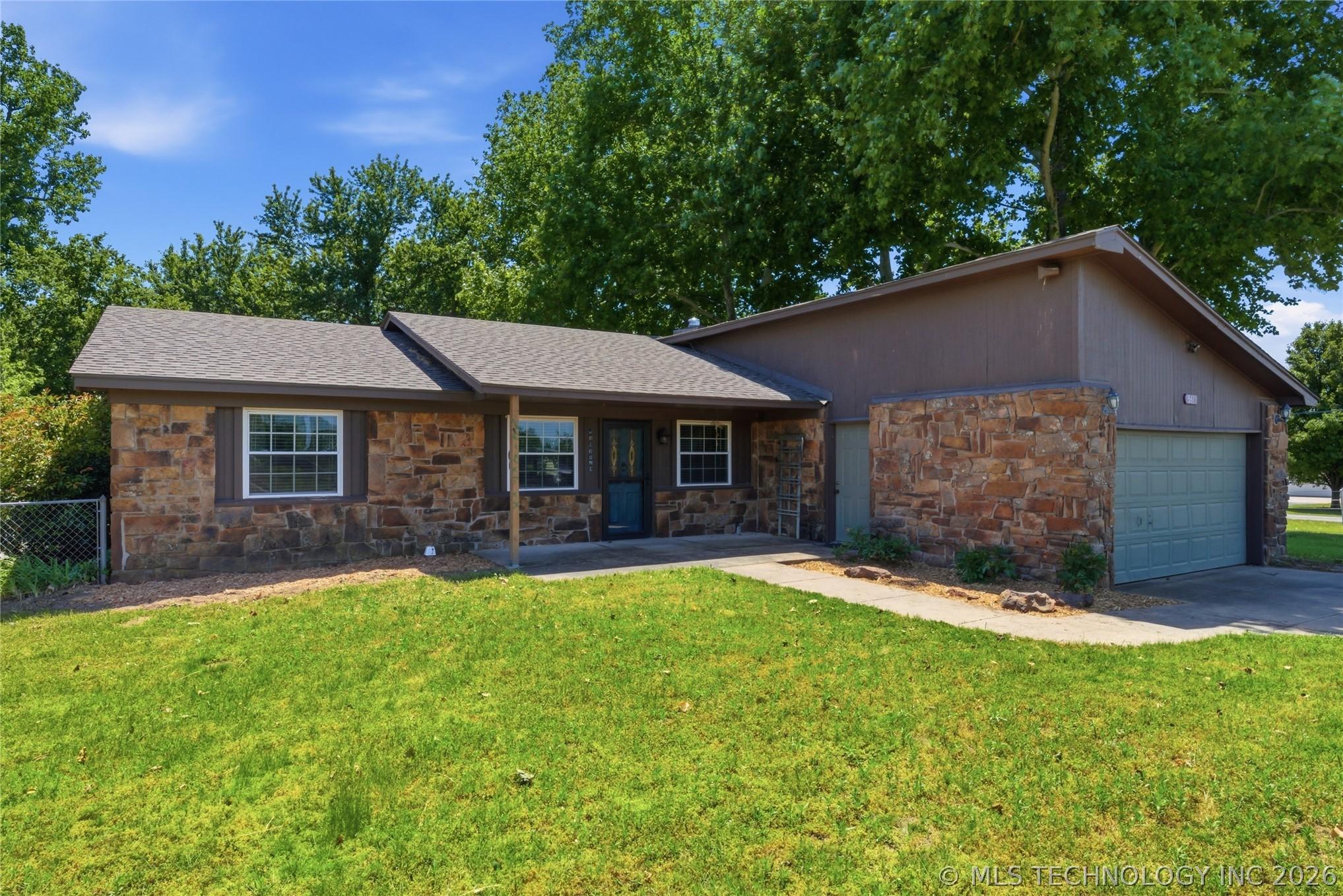 Image 2: Stone exterior with wood-finish siding, featuring