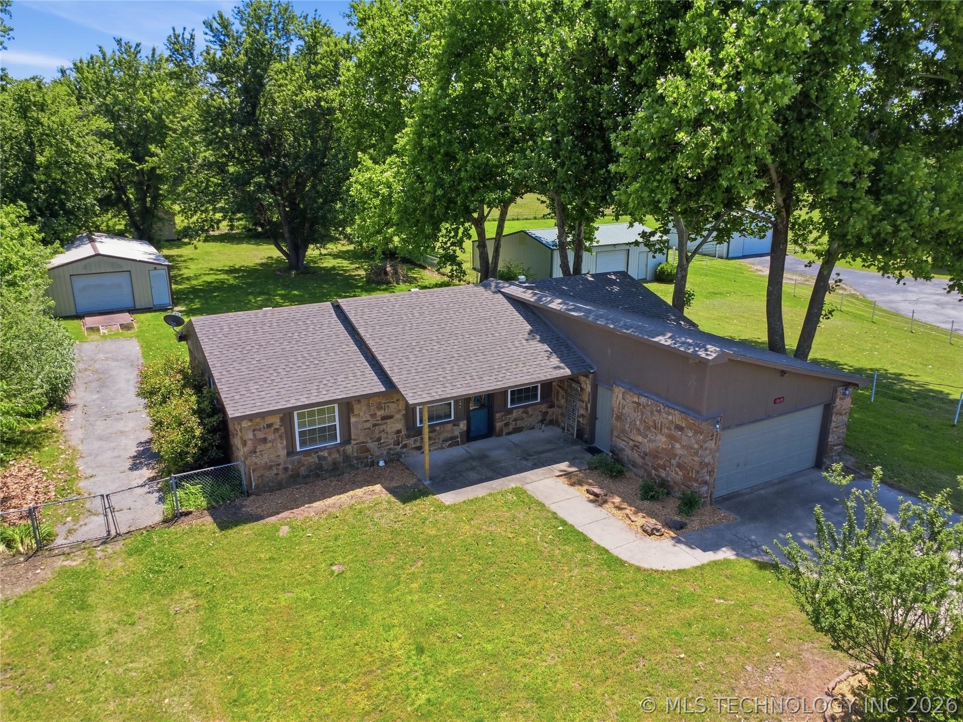 Image 3: Ranch-style residence featuring a stone and wood e