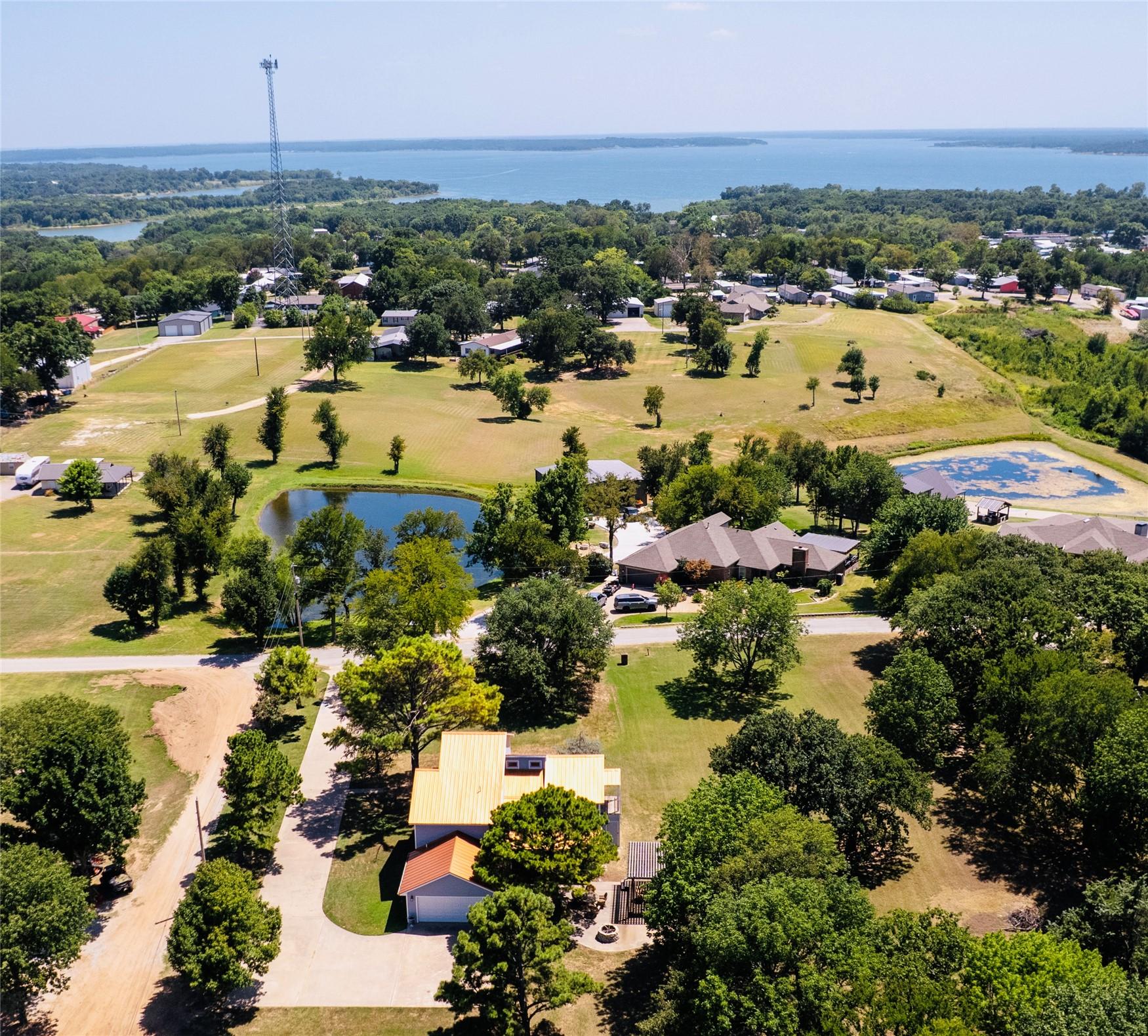 Image 1: Aerial perspective featuring a residential propert