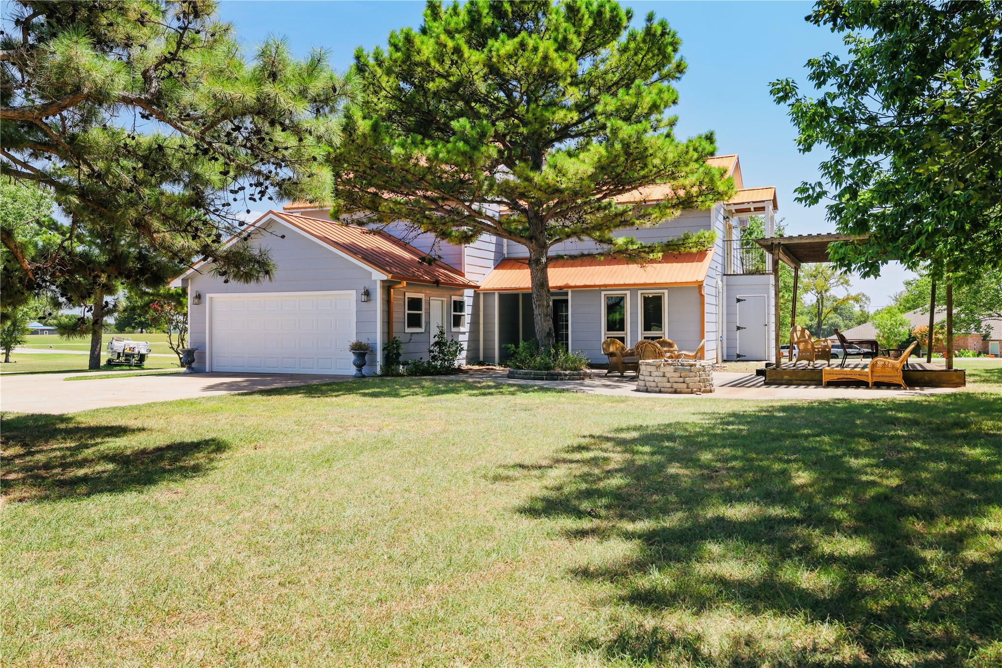 Image 3: Exterior featuring a light gray siding, an orange
