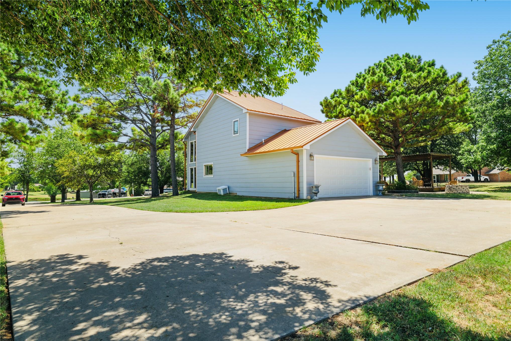 Image 4: Two-story residence featuring light gray siding an