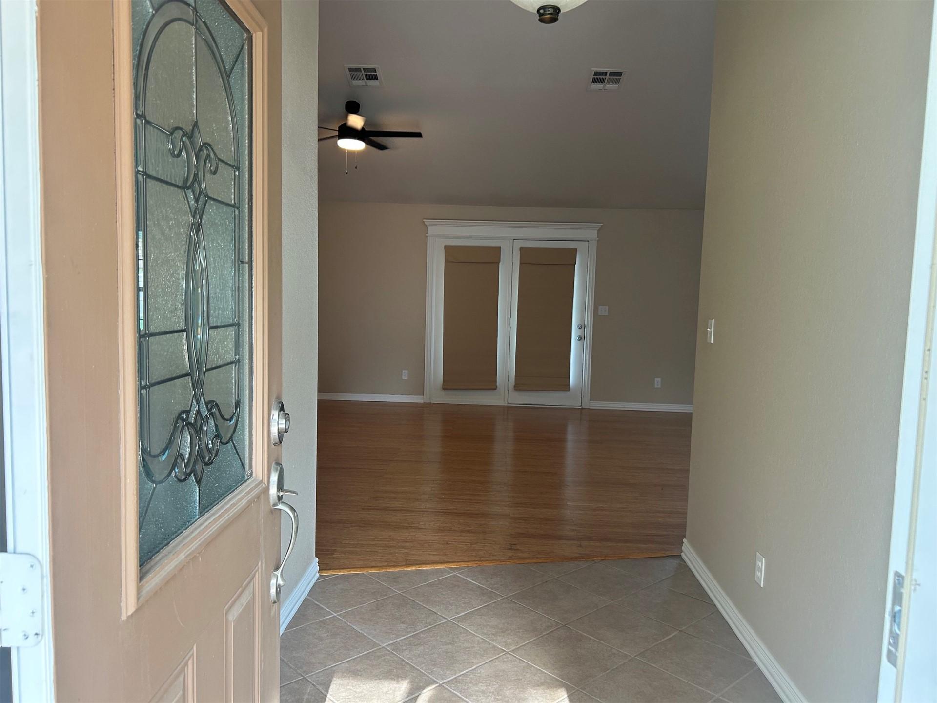 Image 3: Entryway featuring a decorative glass panel door a