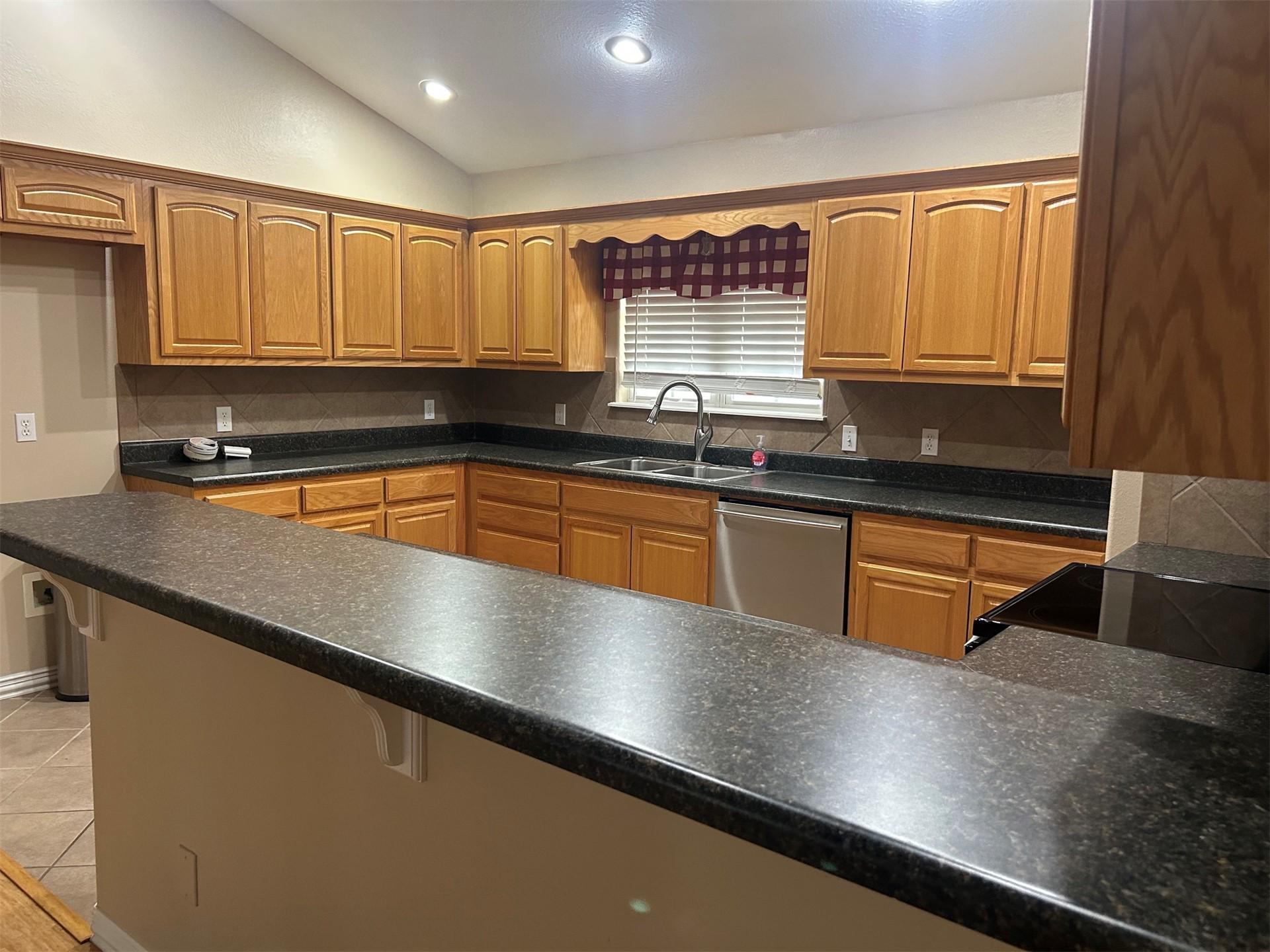 Image 4: Kitchen featuring vaulted ceilings, recessed light