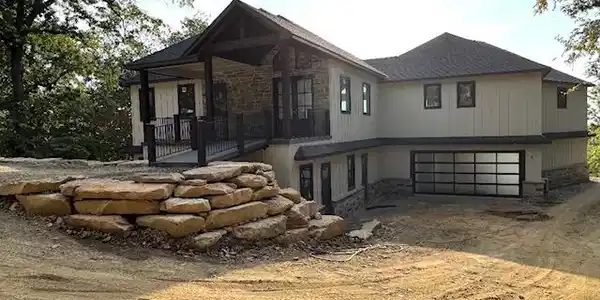 Image 2: Stone and vertical siding exterior with an integra
