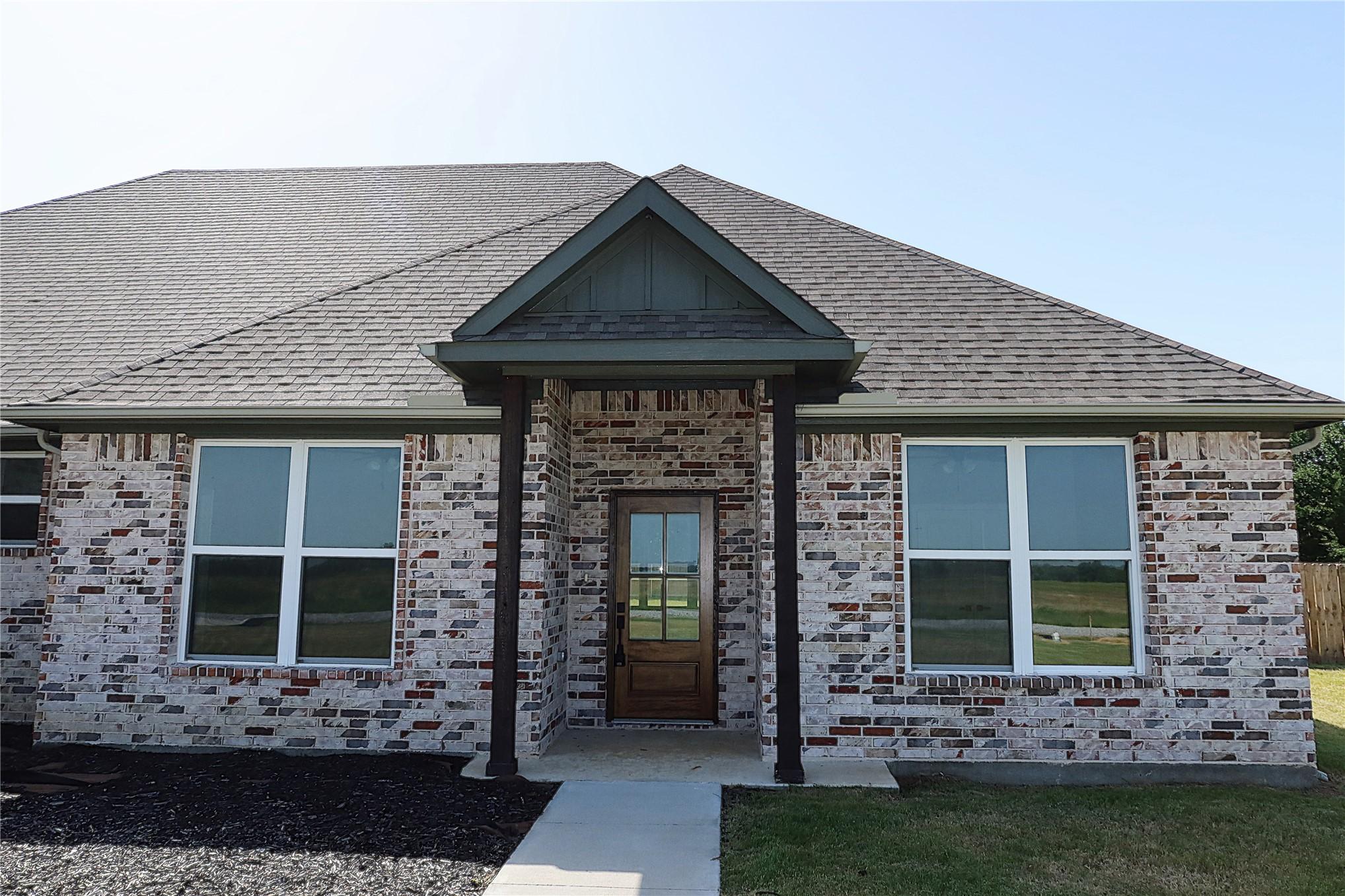 Image 3: Brick-and-stone exterior with black architectural