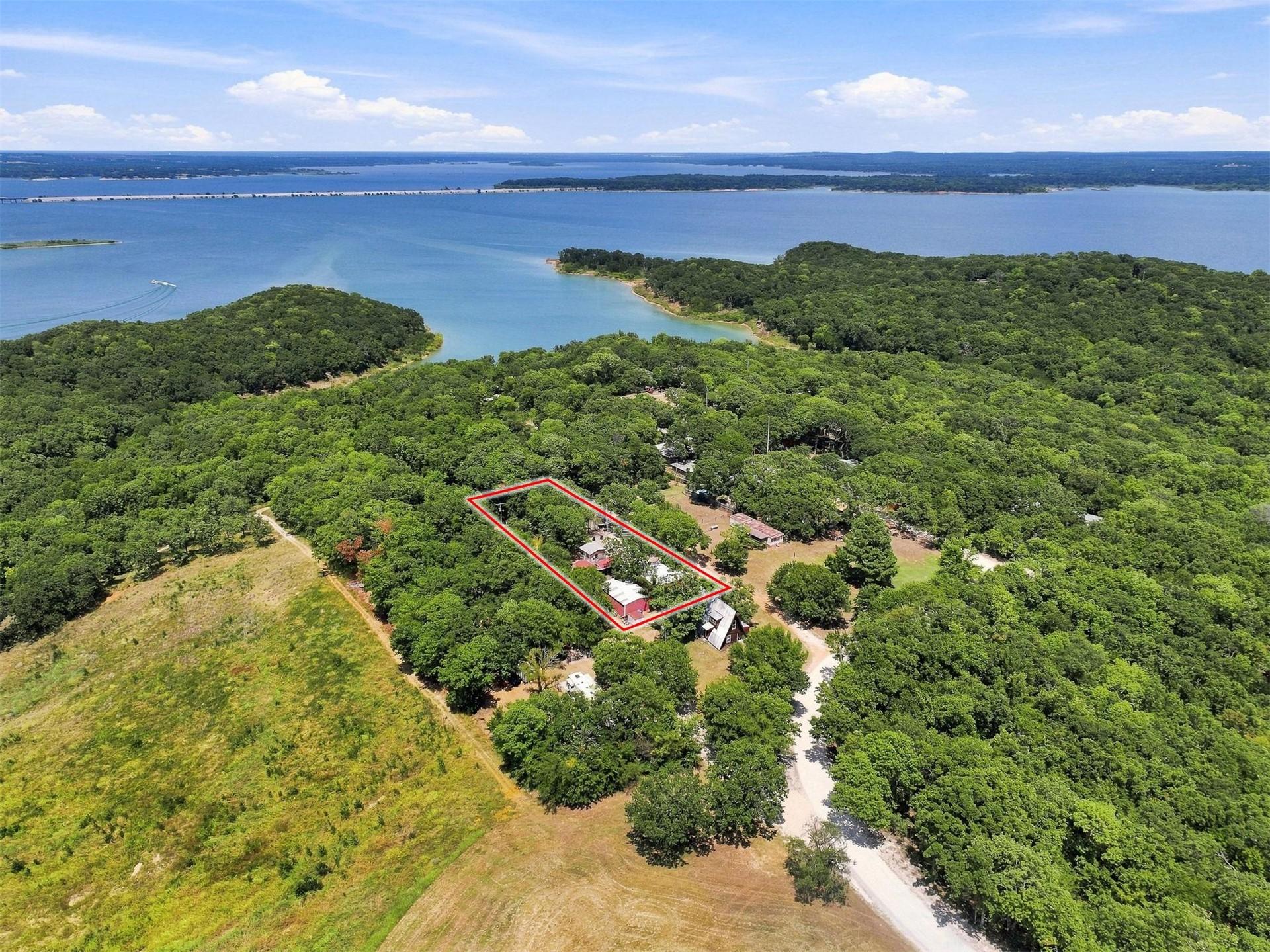 Image 1: Expansive wooded lot with lake access, surrounded