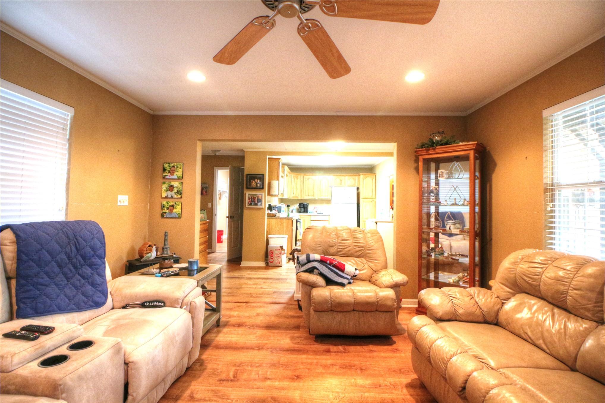 Image 4: Wood-finish flooring, recessed lighting, and a cei