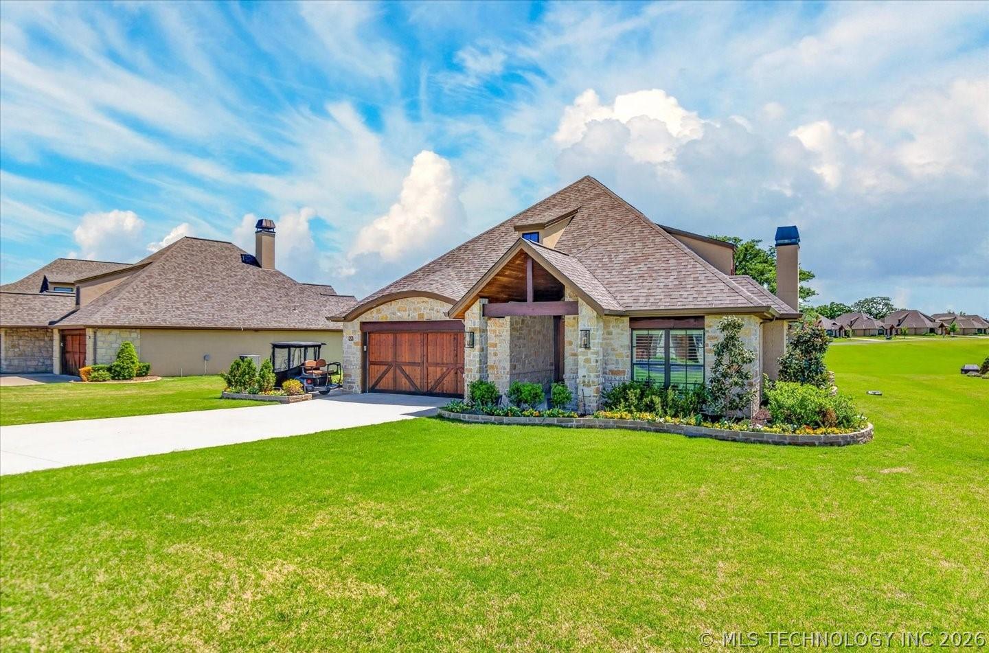 Image 3: This home has raised planters with matching stone