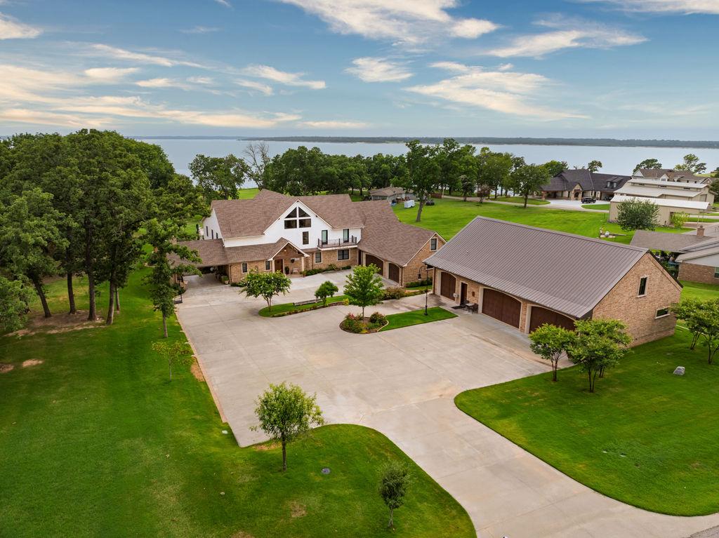 Image 3: Expansive property featuring a large concrete driv