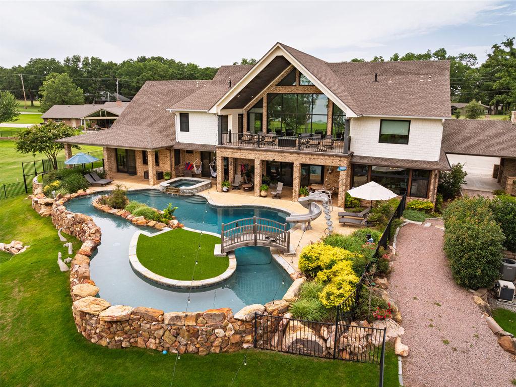 Image 4: Expansive backyard featuring a custom-shaped swimm