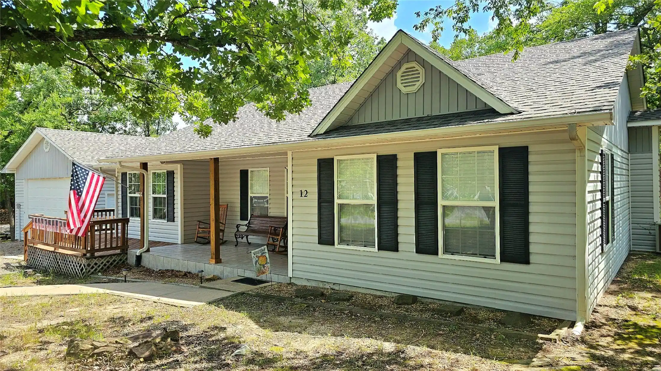Image 1: Light gray siding exterior with dark shutters, a c