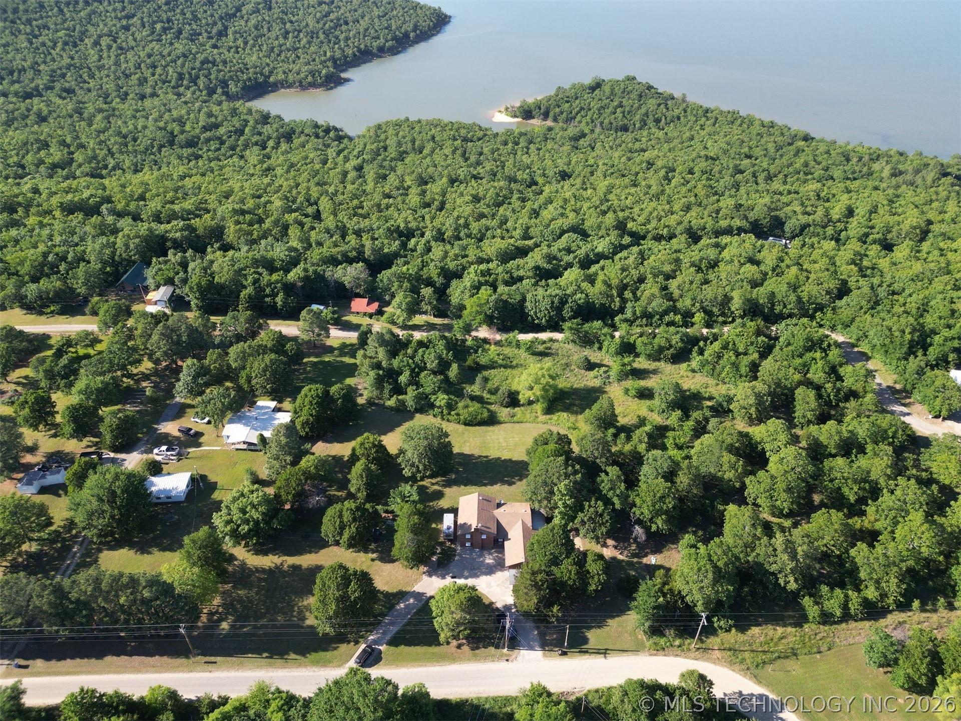 Image 1: Expansive property featuring verdant tree coverage