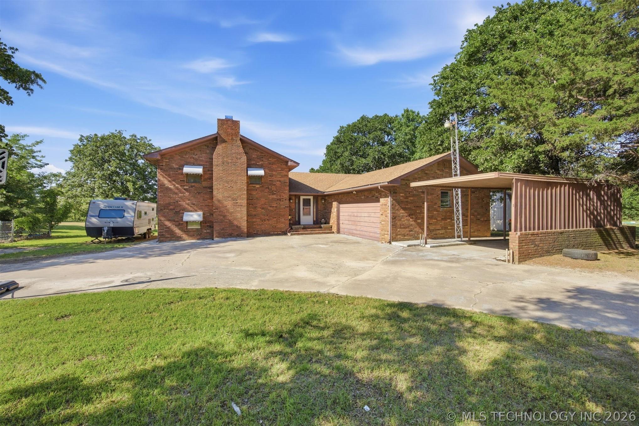 Image 3: Brick exterior residence featuring a prominent chi