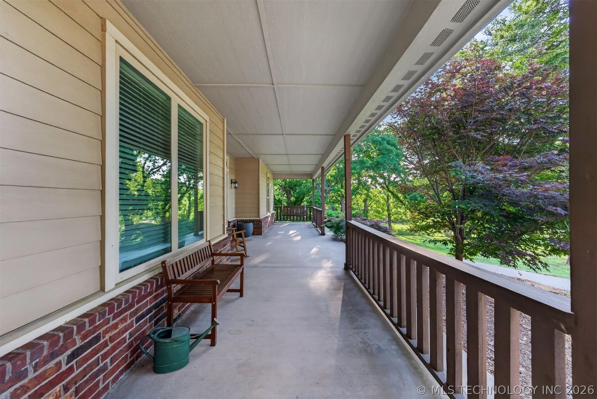 Image 4: Expansive covered porch featuring a concrete surfa
