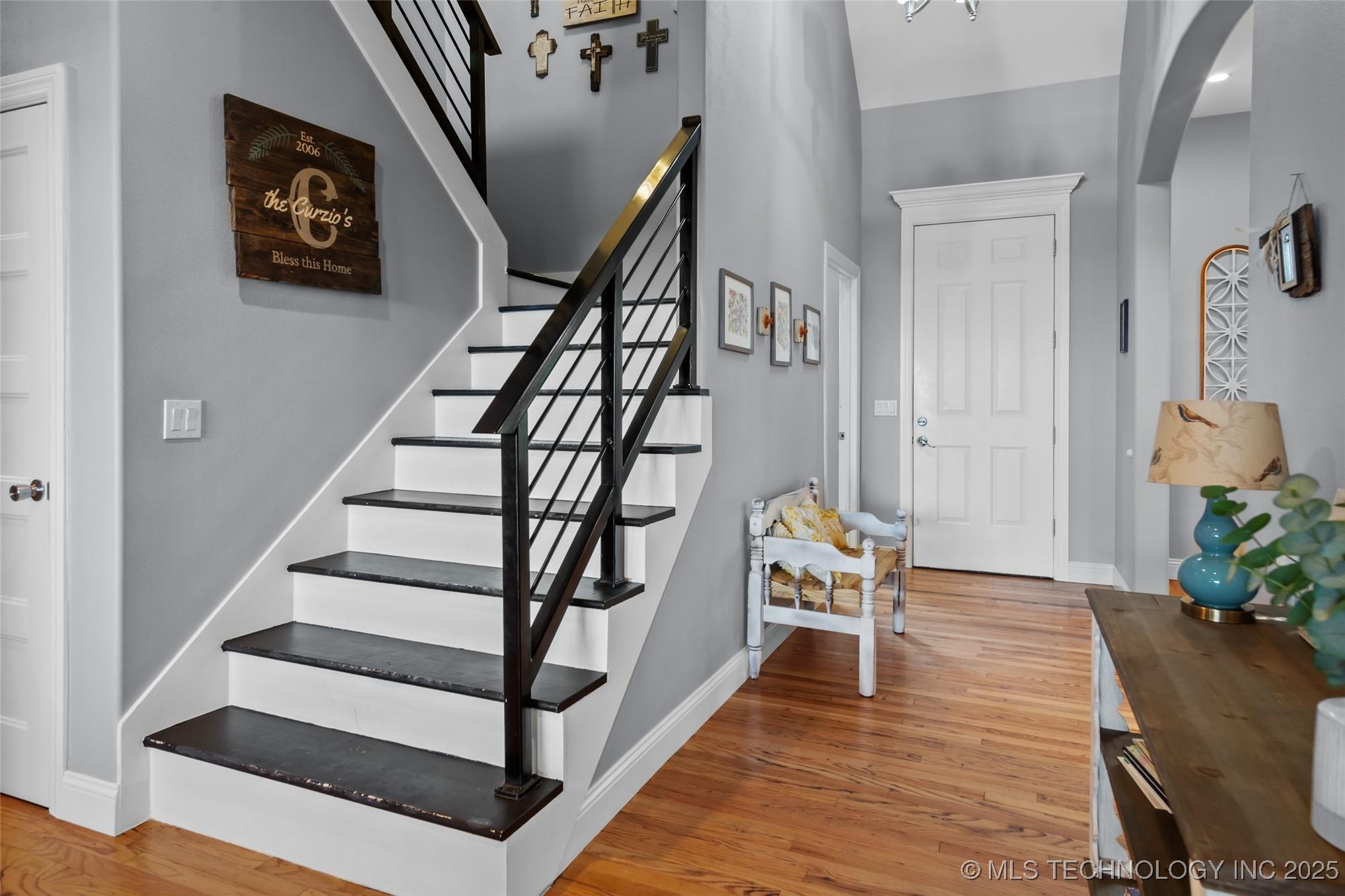 Image 4: Entrance foyer featuring arched walkways, baseboar