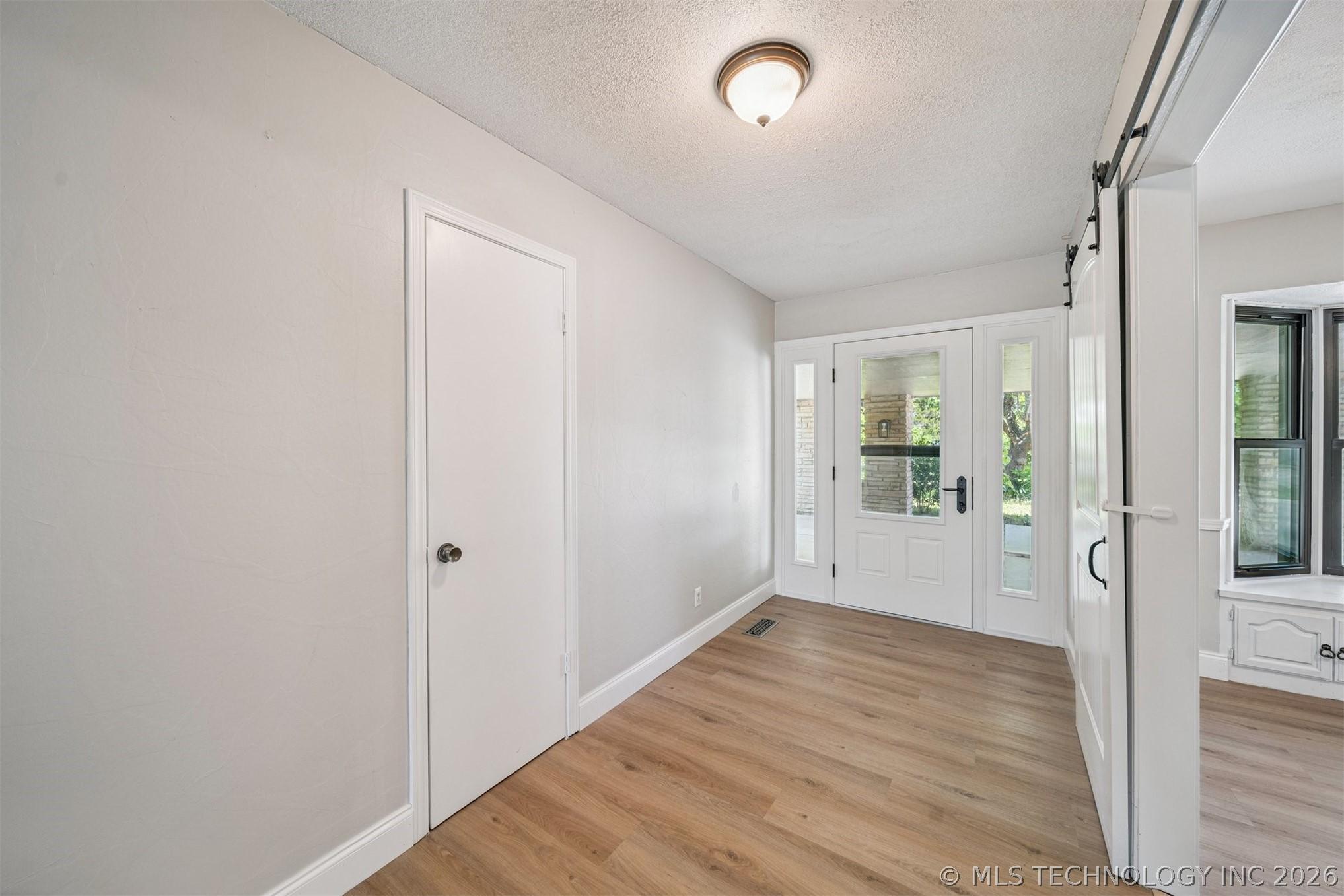 Image 4: Foyer featuring a white front entry door with glas