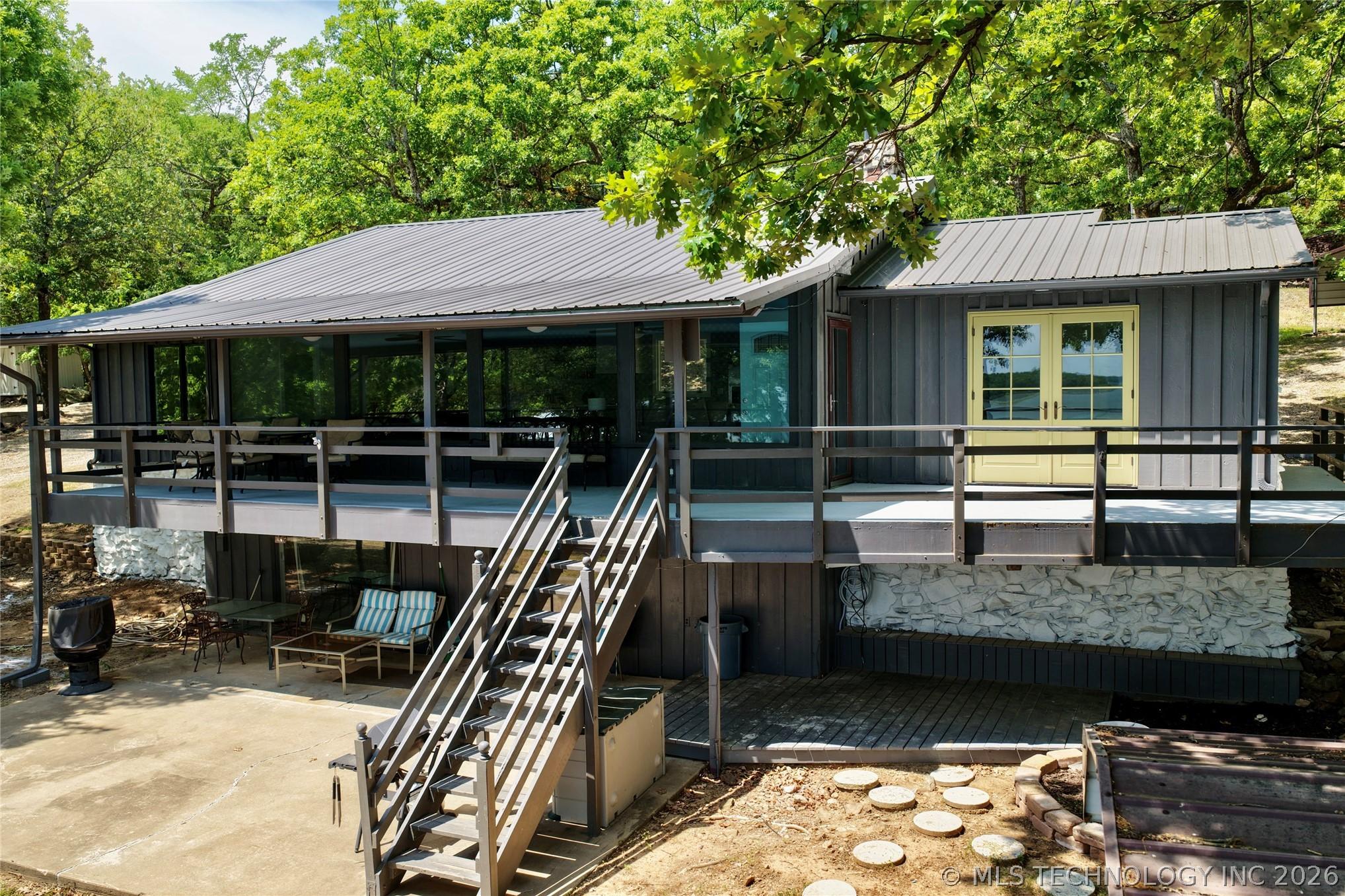 Image 2: Raised residence featuring a metal roof, expansive