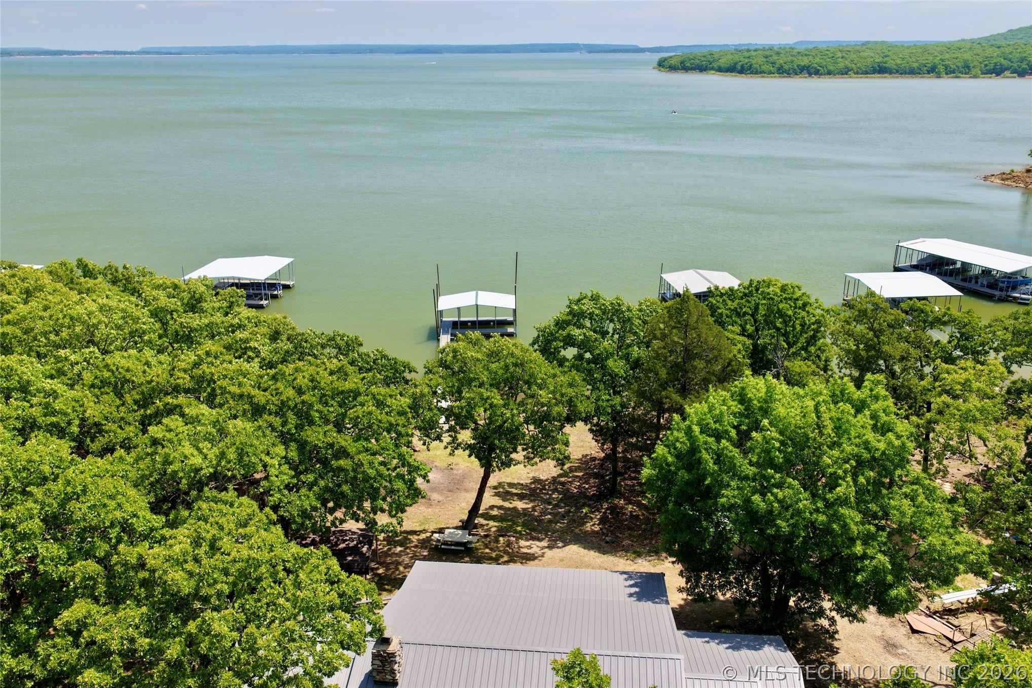 Image 4: Waterfront property featuring extensive tree cover