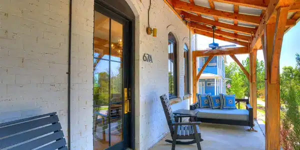 Image 4: Covered porch with exposed wood beams, a ceiling f