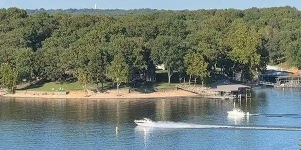 Image 2: Waterfront property featuring a sandy beach fronta
