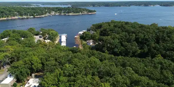 Image 4: Waterfront property featuring mature tree-lined gr