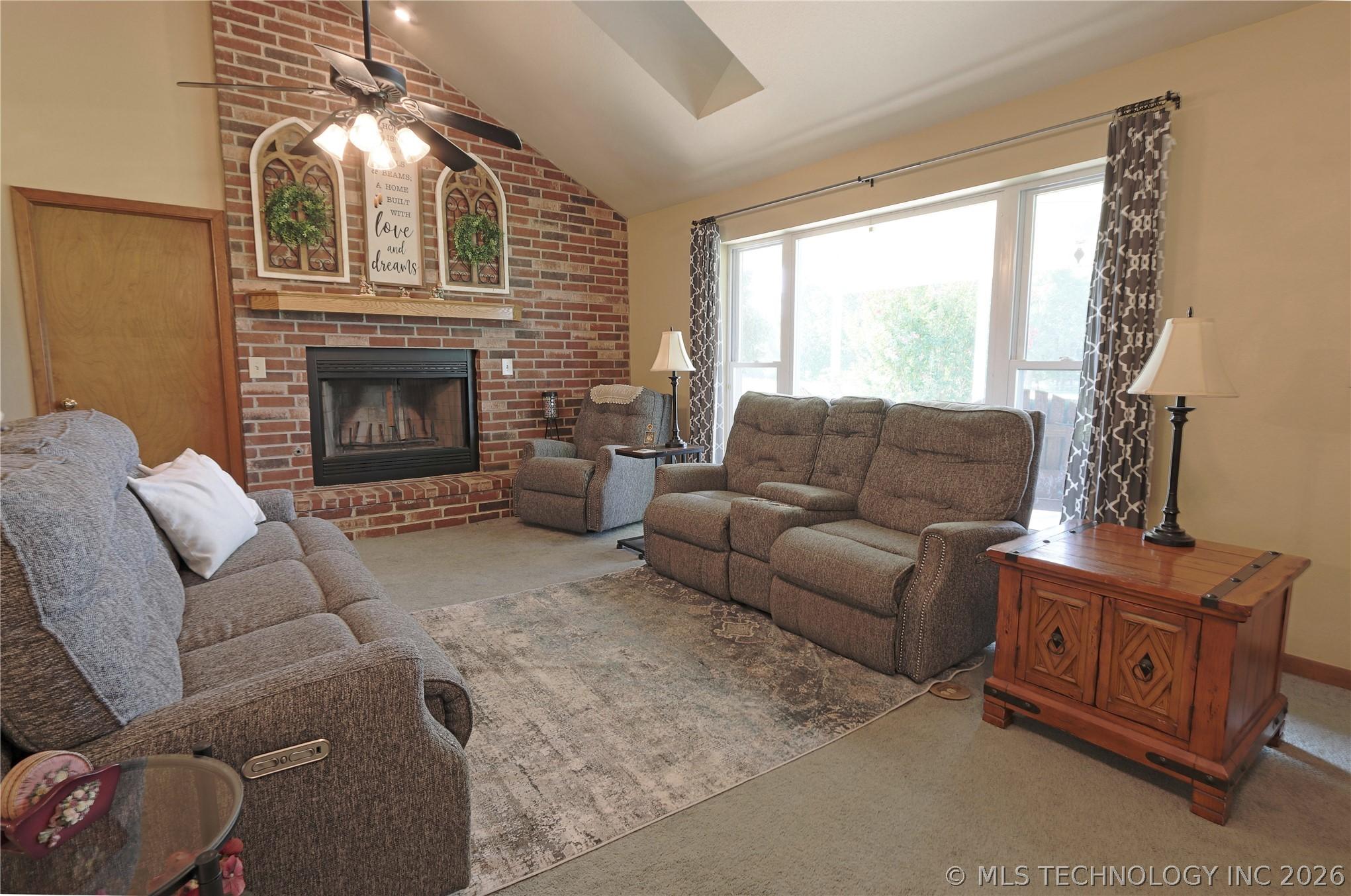 Image 3: Large open living area with fireplace.