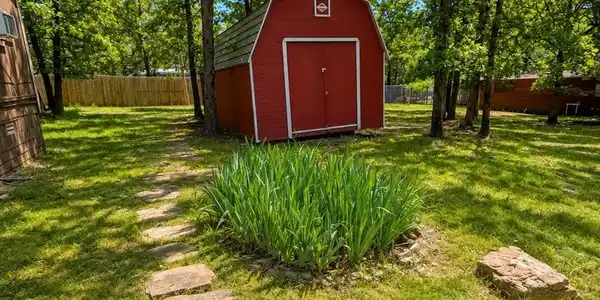 Image 3: Red barn-style shed with a gambrel roof and double