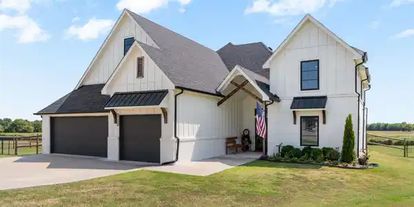 Image 4: Modern farmhouse exterior with white board-and-bat