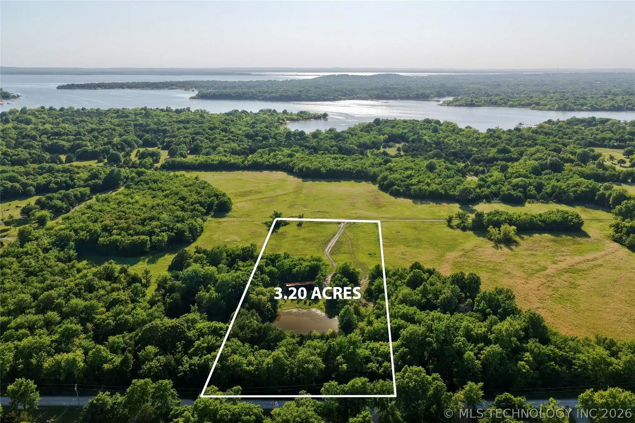Image 1: 3.20-acre parcel featuring a private pond and a mi