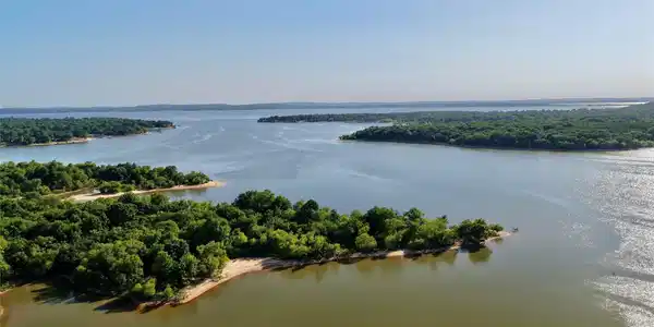Image 3: Expansive waterfront acreage featuring sandy shore