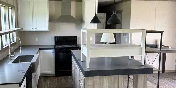 Image 4: White cabinetry with dark countertops, stainless s