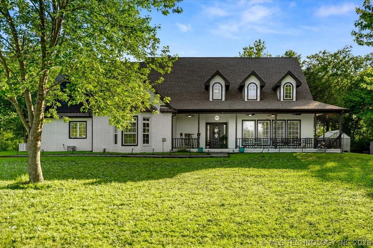Image 3: White brick exterior with dark trim accents and a