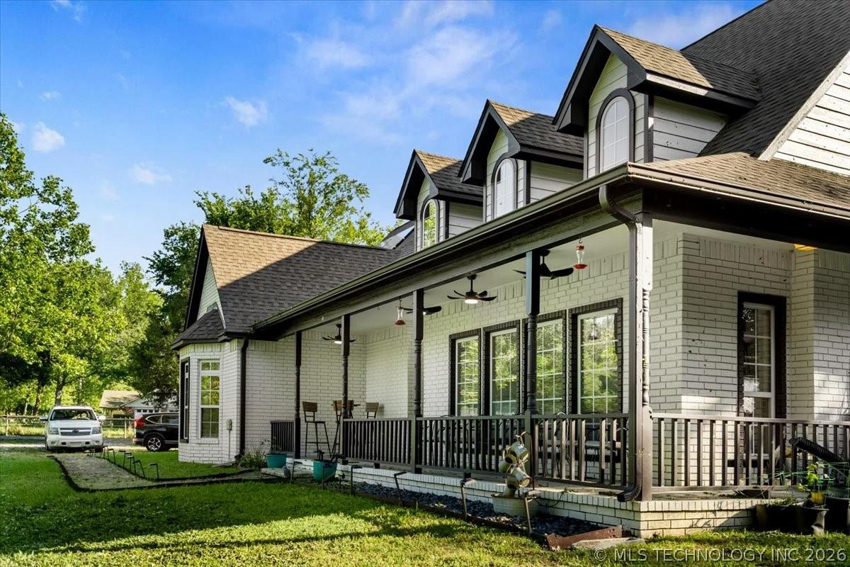 Image 4: White brick exterior featuring a covered porch, mu