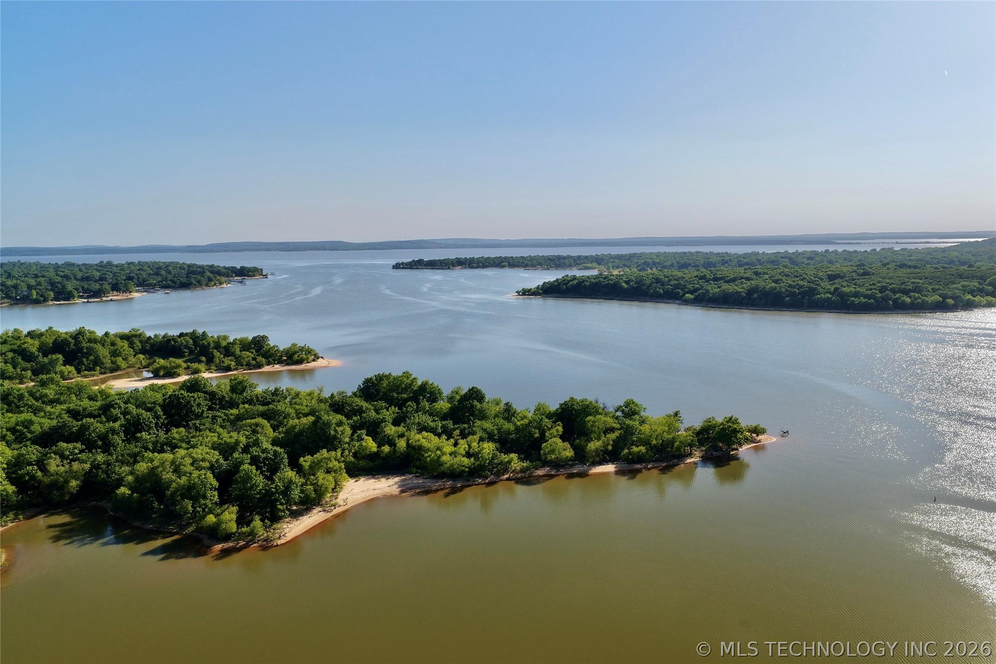 Image 3: Expansive waterfront acreage featuring sandy shore