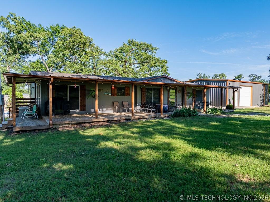 Image 1: Covered patio along the entire front of the home