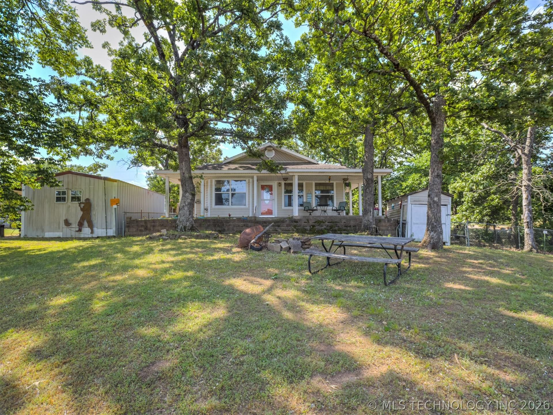 Image 2: Ranch-style exterior with a covered front porch, s