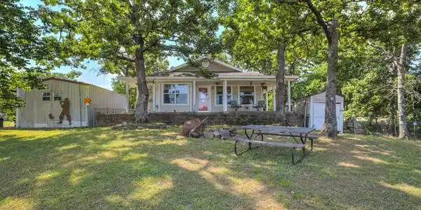 Image 2: Ranch-style exterior with a covered front porch, s