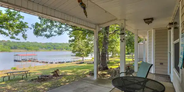 Image 4: Covered patio with a concrete surface, providing d