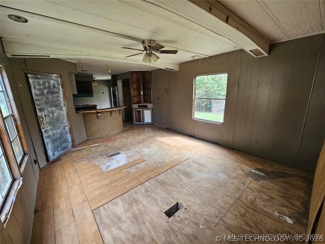Image 3: Open-concept interior featuring paneling walls and