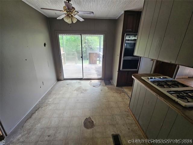 Image 4: Kitchen area featuring a built-in double oven, gas