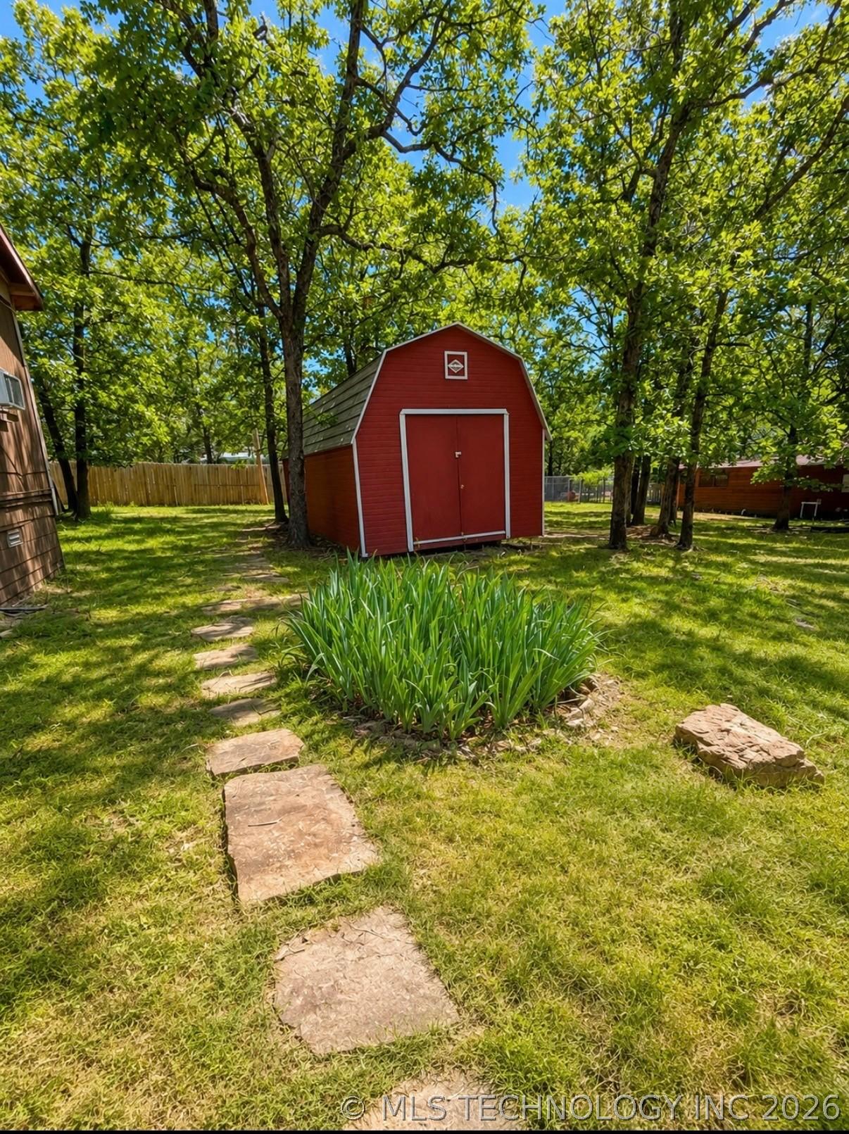 Image 3: Red barn-style shed with a gambrel roof and double