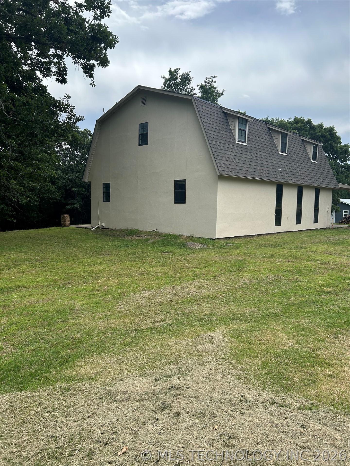 Image 2: Gambrel-style residence featuring a light-colored