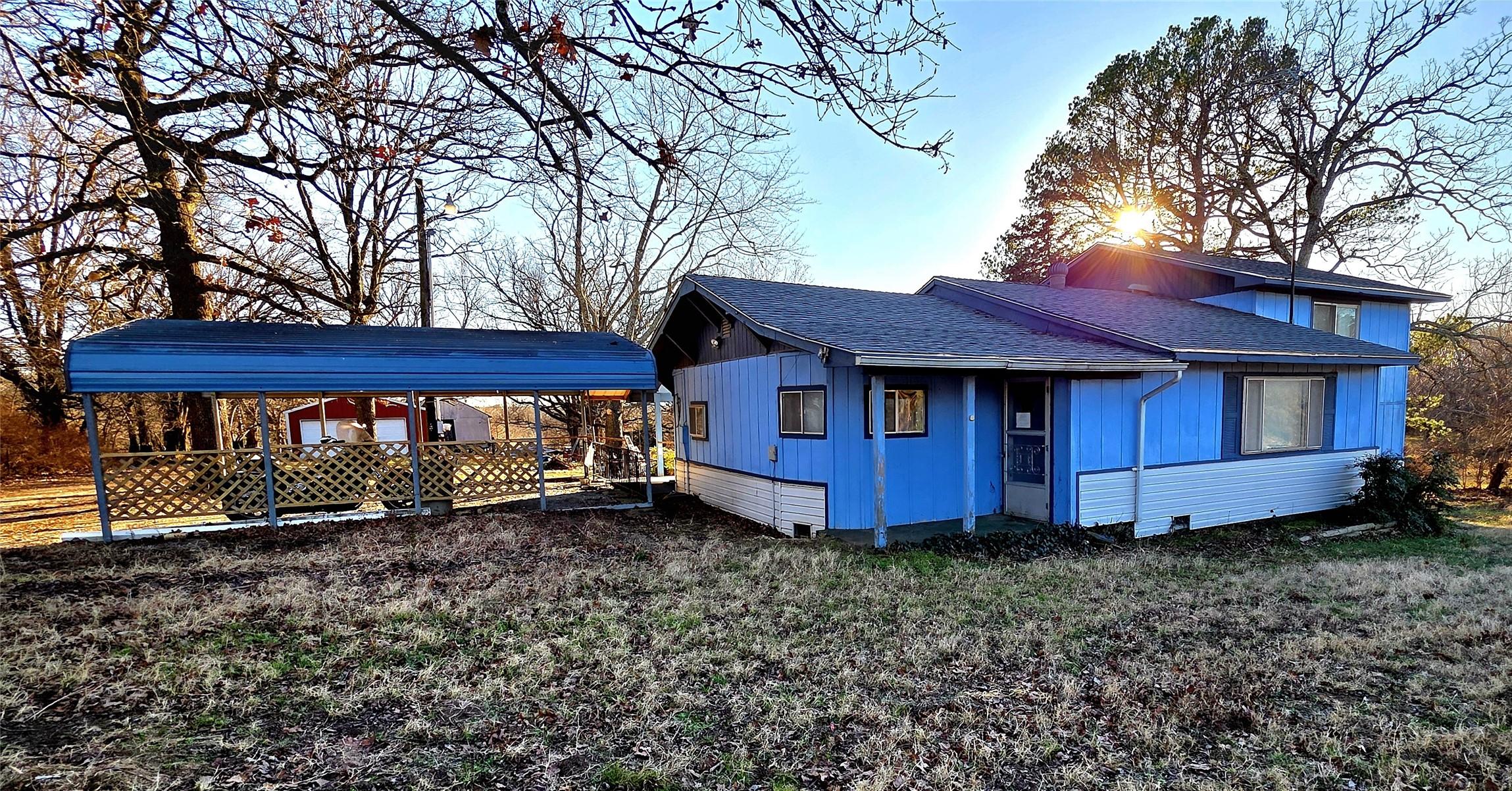Image 1: Front left view of the home with covered parking.